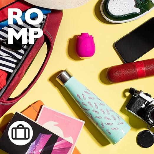 Flat lay of a stylish bag, water bottle, camera, and various accessories on a yellow background with the ROMP logo.