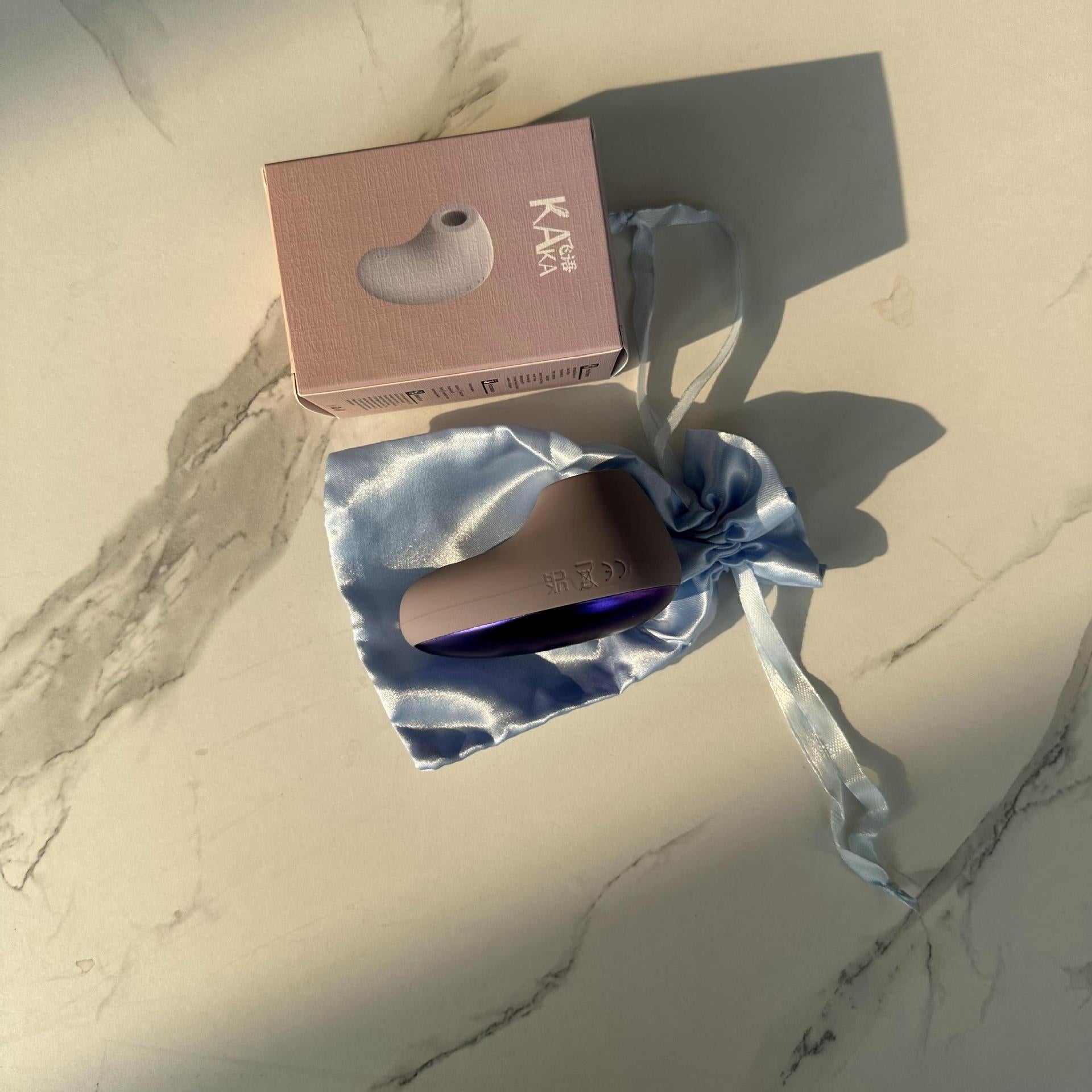Suction vibrator packaging with satin storage pouch
